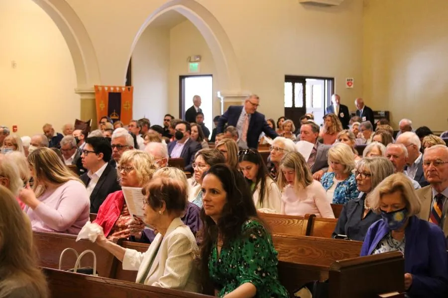 Four dozen attendees fill the back pews in the SMCC sanctuary.